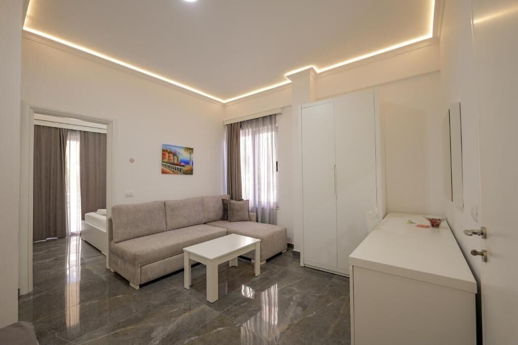 A modern living room with a sofa, a coffee table, and a cabinet.