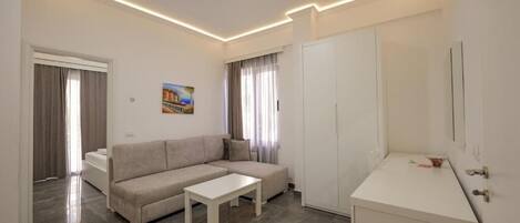 A modern living room with a sofa, a coffee table, and a cabinet.
