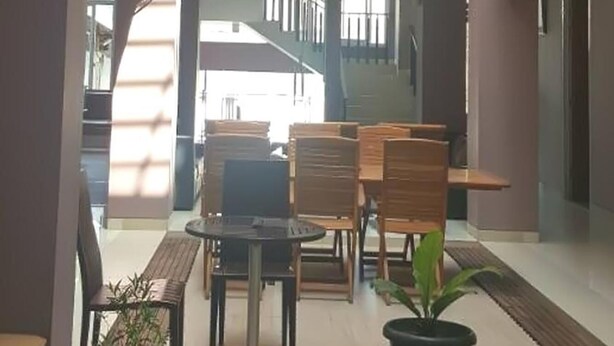 A multi-level atrium with a central open space, seating areas, and a balcony. - Hotel Amalia Malioboro (Yogyakarta)