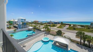 A resort with a large pool area, a view of the ocean, and a road leading to the beach. - 30A Retreat - 2 Homes, Gulf Views, Great for Large Groups! (Santa Rosa Beach)