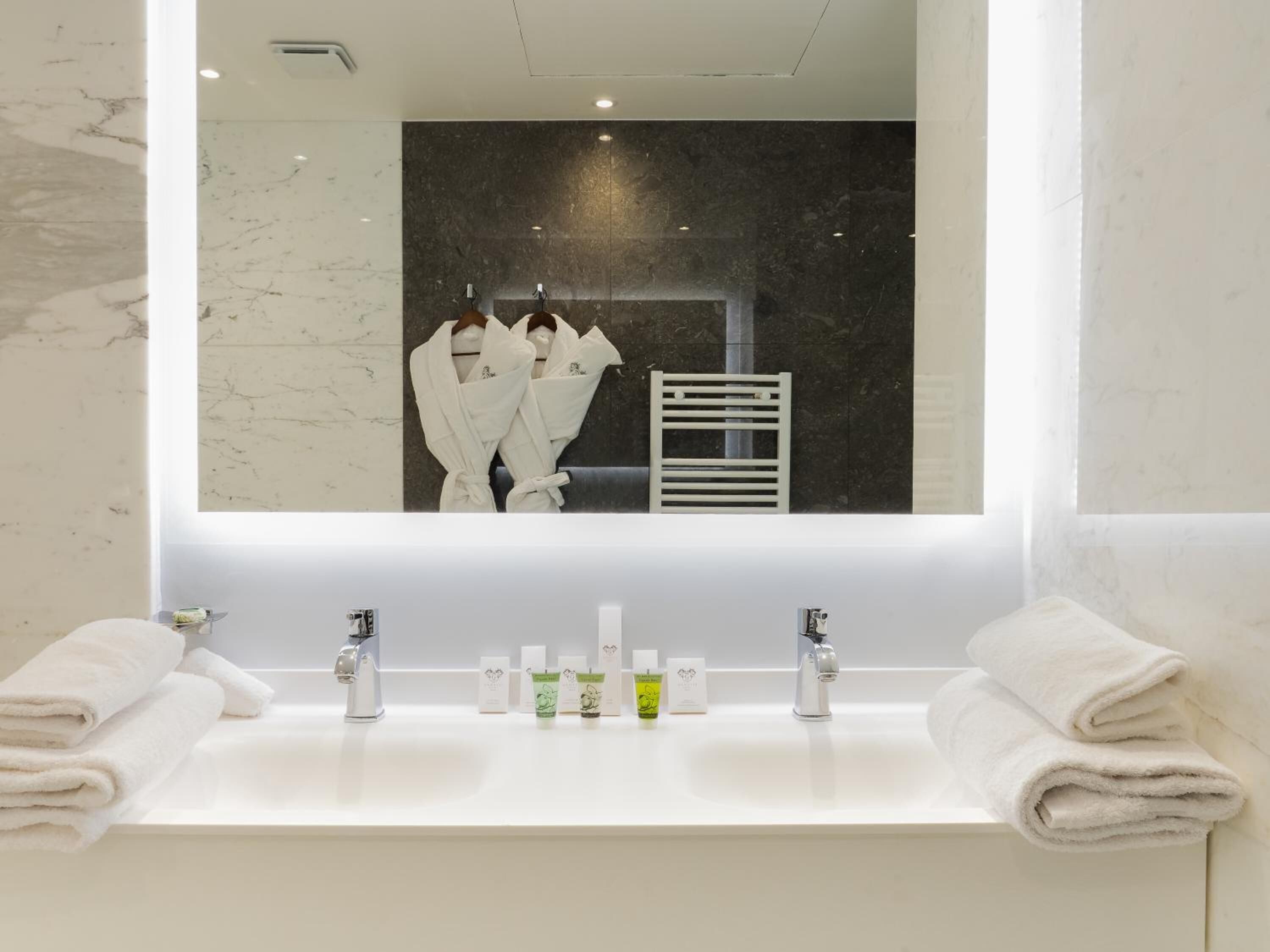 designer toiletries, hair dryer, bathrobes, slippers