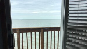 A wooden deck with a view of the ocean. - Beautiful house right at the beach (Oak Harbor)