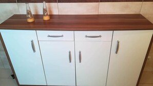 A kitchen with a wooden countertop, two cabinets with silver handles, and two glass bottles on the counter. - Casa da Avó near the beaches of the western zone (Óbidos)
