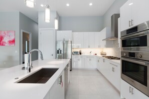 Fridge, microwave, oven, stovetop - Modern Luxury Villa | Splash Pad, Car Pool Table, Movie Room, Custom Kid Bedroom (Kissimmee)