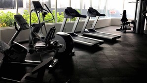 A gym with treadmills and exercise equipment, large windows, and a view of the outside. - Excellent Location Premium Studio @ Palo 101 Ipoh (Kampung Jawa)