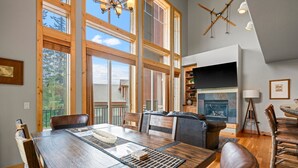 A spacious dining area with a large wooden table, leather chairs, and a fireplace. - Ping Pong, Foosball, Pet Friendly, Mountain Living (Durango)