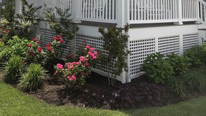 A two-story house with a covered porch, white railings, and a small garden with pink flowers. - Walkable Location Cape May Home w Pool, 1st-Fl BR, Near Dining, Market & Beach (West Cape May)