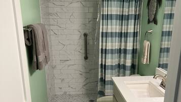 Combined shower/tub, hair dryer, towels, soap