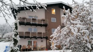 A multi-story building with balconies, a door, and windows. - Apartment Stein by Interhome (Pians)