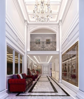 A grand hallway with a chandelier, red sofas, and a marble floor. - Villa De Khaosan (Bangkok)