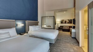 A hotel room with two beds, a desk, a chair, and a large mirror. - SpringHill Suites by Marriott Montgomery Downtown (Montgomery)