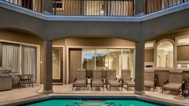 A pool area with lounge chairs and a covered seating area. - 1/2 Block From Private Beach, 7 BR, Remodeled, Theater, Discounted Golf Cart (Miramar Beach)