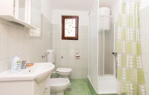 A small bathroom with a sink, toilet, and shower. - 2 bedroom amazing apartment in Razanac (Razanac)