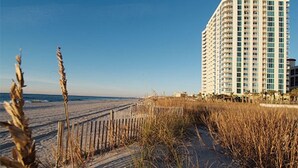 A beachfront hotel with a modern design, featuring multiple floors and balconies. - One-Bedroom Oceanfront Condo on Myrtle Beach (North Myrtle Beach)