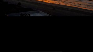 A sunset over a beach with a clear sky. - S. Myrtle Beach Resort 135 steps to sand  (Myrtle Beach)