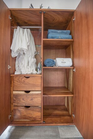 A wooden wardrobe with multiple compartments, including hanging space, shelves, and drawers. - A Villa San Juan Bed & Breakfast (Nuevo Nayarit)