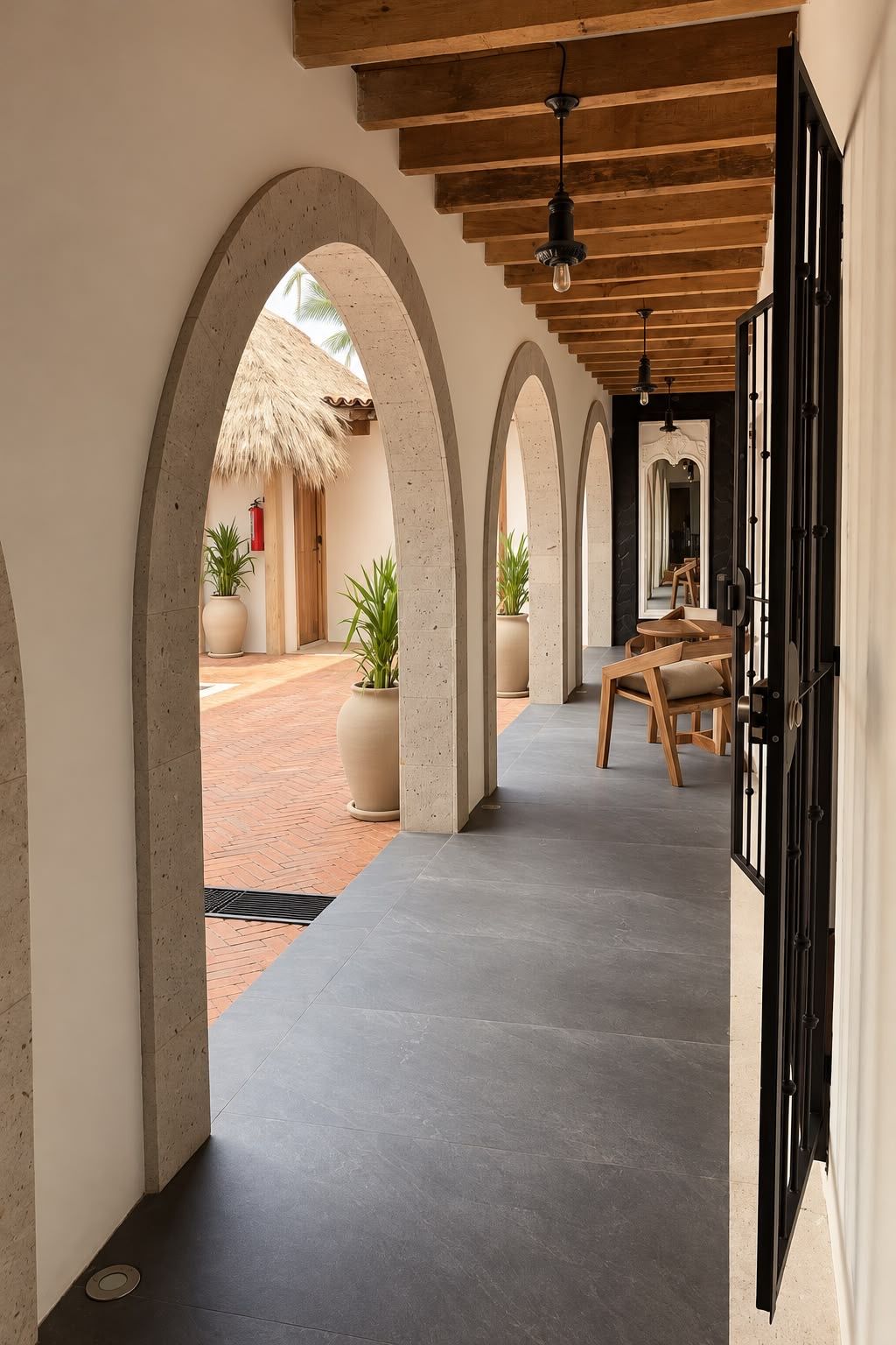 A corridor with arched ceilings, potted plants, and a wooden bench.