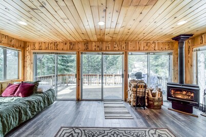 Rustic home with a wood stove, private dry sauna, & two decks with forest views