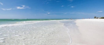 Beachy villa on Siesta Key with heated pool, screened in lanai, and ground level