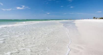 Beachy villa on Siesta Key with heated pool, screened in lanai, and ground level