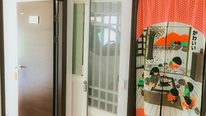 A room with a sliding door marked '101', a sliding glass door, and a traditional Japanese sliding door with a colorful design. - Aegean Sea Homestay (Magong)