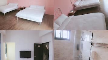 A hotel room with two beds, a TV, a bathroom with a shower, and a hallway leading to a staircase.