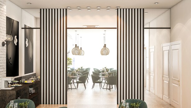 Un comedor moderno con una isla central, separador a rayas blanco y negro, y lámparas colgantes.