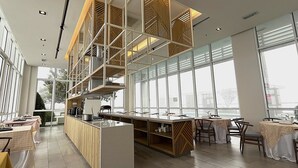 A modern kitchen with a central island, large windows, and a high ceiling with exposed beams. - Swiss-Garden Hotel & Residences, Genting Highlands (Genting Highlands)