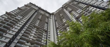 A high-rise building with multiple balconies and a modern architectural design.