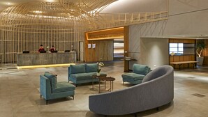A spacious lobby with a reception desk, seating area, and a modern ceiling design. - Swiss-Garden Hotel & Residences, Genting Highlands (Genting Highlands)