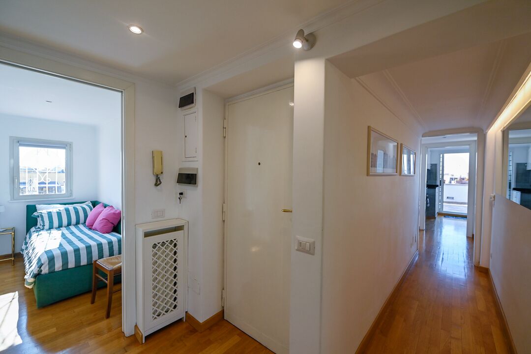 Une chambre à coucher avec un lit, une fenêtre et une porte donnant sur une autre pièce.
