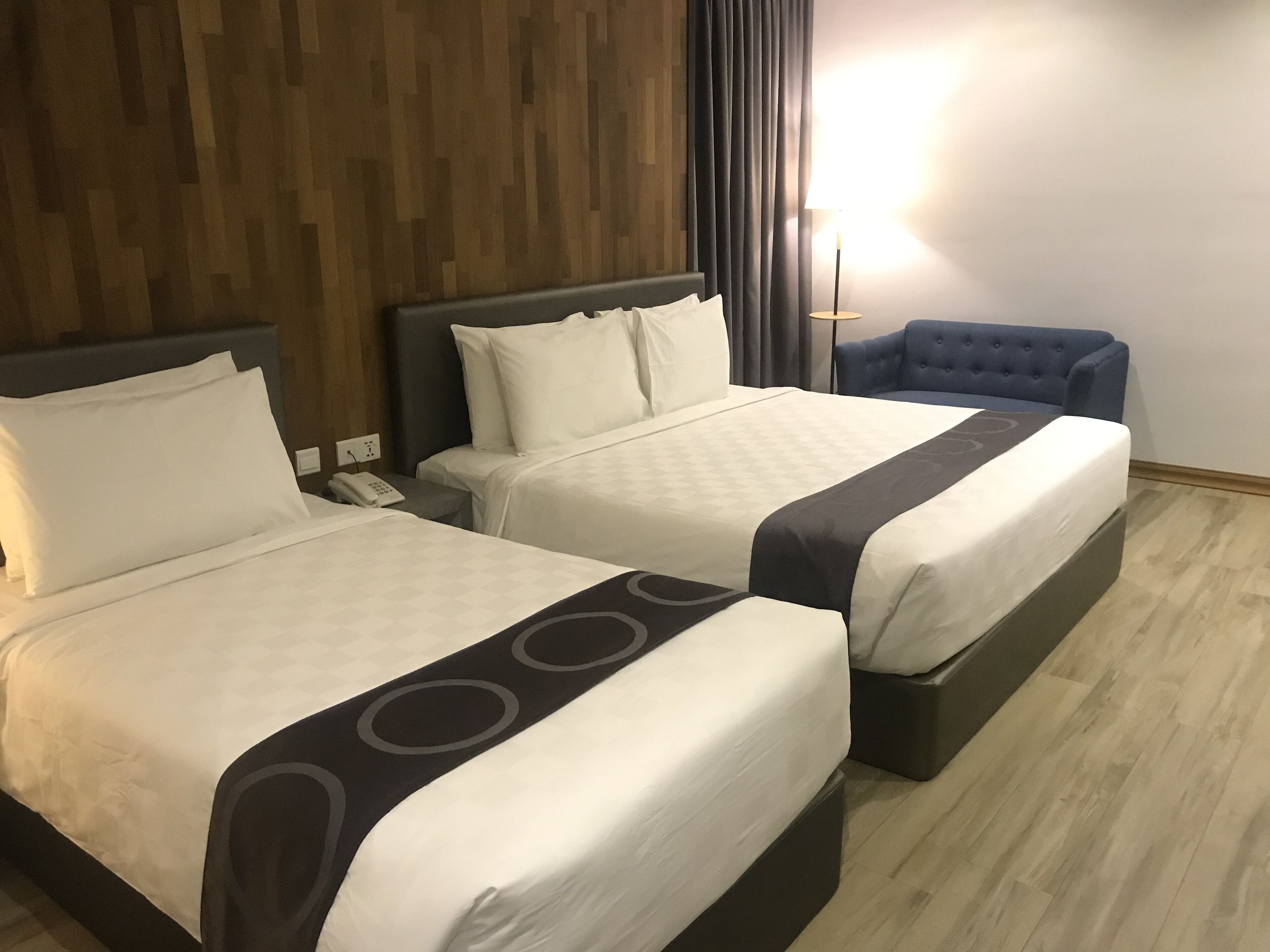 deluxe triple room, city view | in-room safe, desk, laptop workspace, iron/ironing board