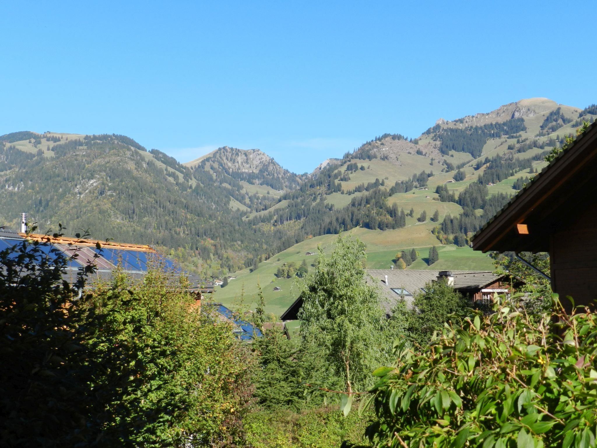 A mountain landscape with houses and greenery.