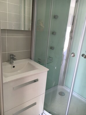 Shower, hair dryer, towels, toilet paper