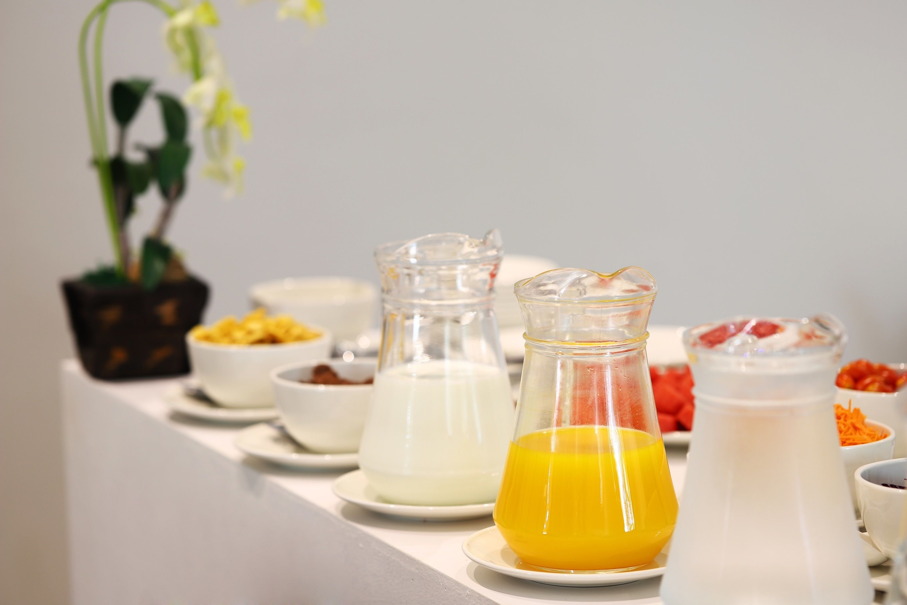 A breakfast buffet with various food items and beverages.