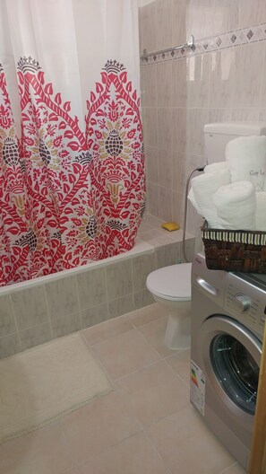 Bathtub, hair dryer, towels, soap