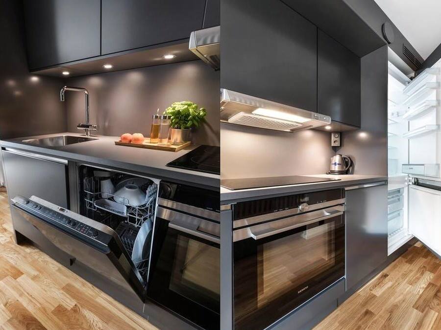 A modern kitchen with a built-in dishwasher, oven, and a large refrigerator.