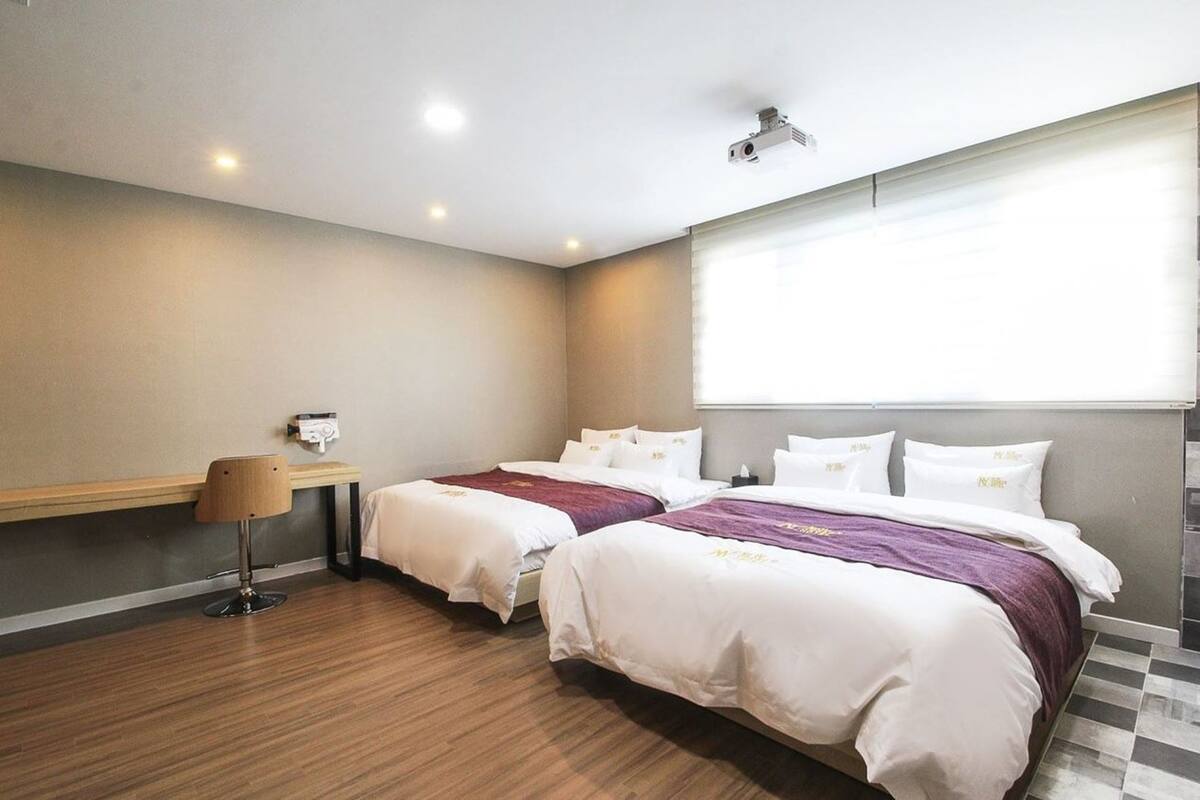 Premium bedding, down duvets, desk, laptop workspace