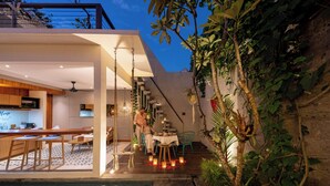 A modern interior with a kitchen, dining area, and a pool.