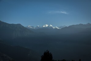 A mountain range with snow-capped peaks under a clear sky. - Udaan Olive Hotel & Spa Pelling (Gyalshing)