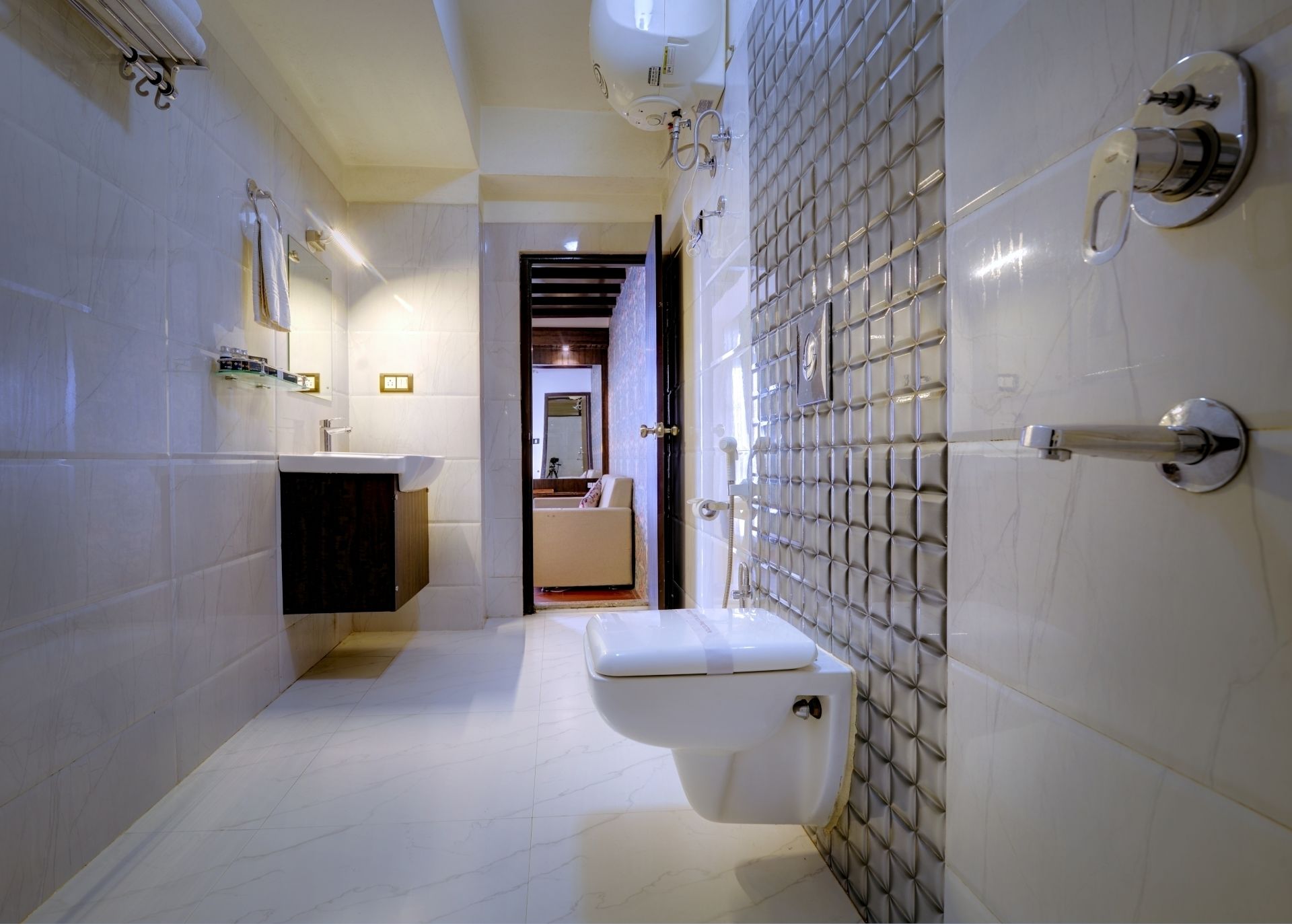 A modern bathroom with a toilet, sink, and shower area.