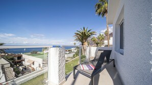 A balcony with a view of the sea, a lounge chair, and a small garden area. - Refurbished 1-bed in popular Los Gigantes w/large terrace, sea & cliff views (Los Gigantes)