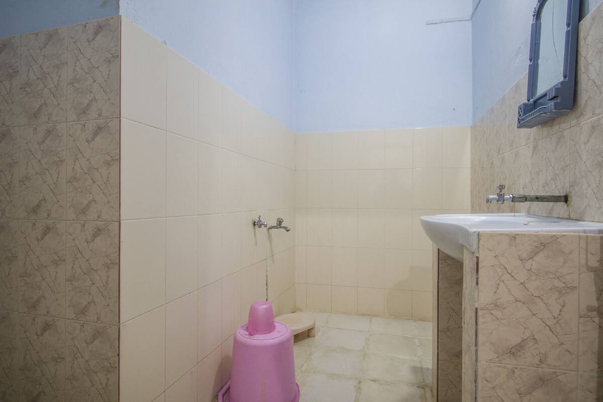 A bathroom with a sink, a toilet, and a shower.