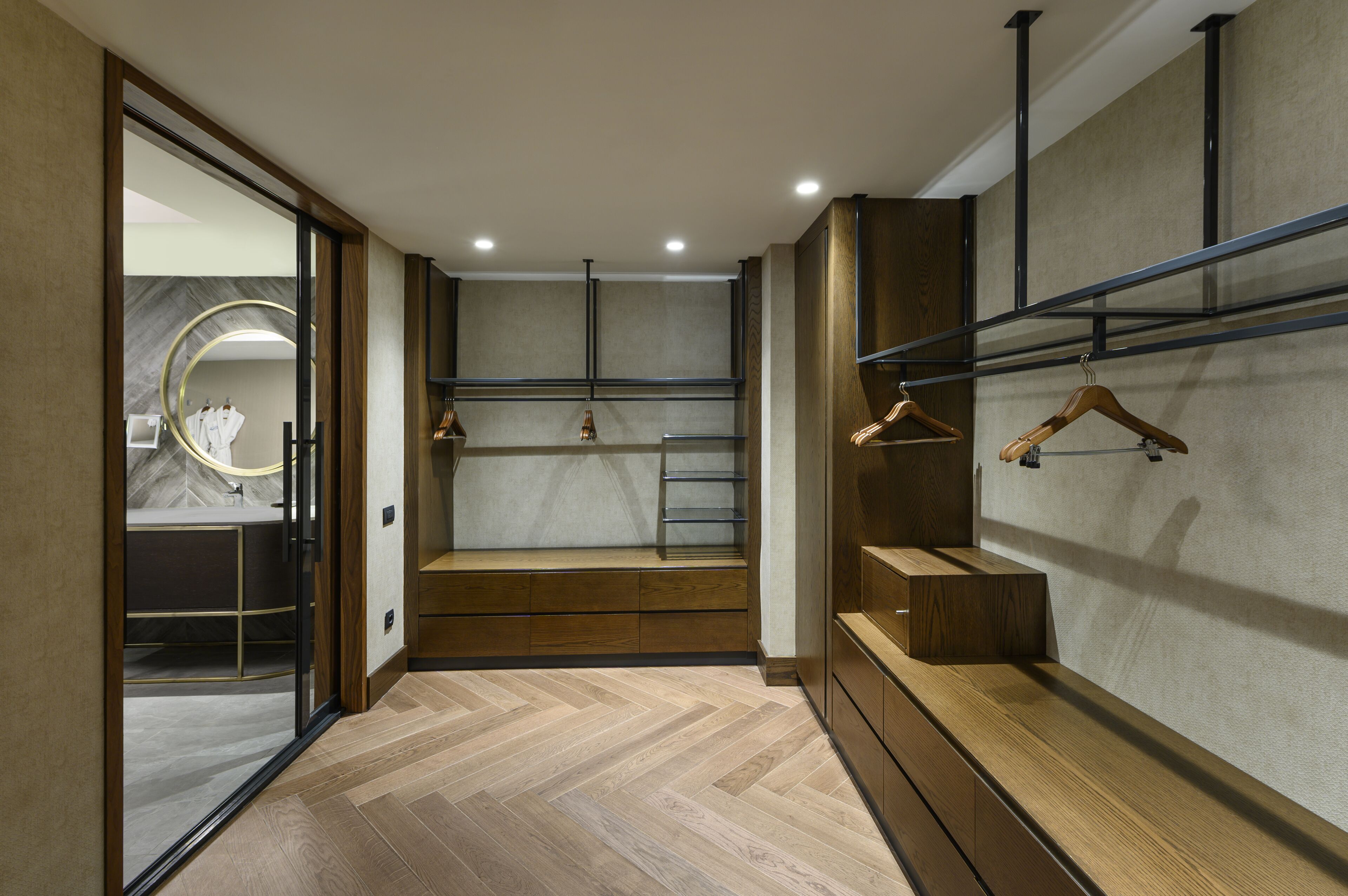 A modern bathroom with a vanity, a mirror, and a shower area.