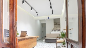 A room with a wooden desk, a chair, a potted plant, and a patterned floor. - 9Bodrum Butik Hotel (Bodrum)