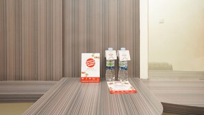 A conference table with a printed brochure and two water bottles with labels.