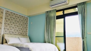 A bedroom with a bed, an air conditioner, a window with curtains, and a view of a balcony. - Letes stay (Shoufeng)