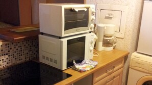 A compact kitchen with a microwave, coffee maker, and washing machine. - PARIS_BNF Economical, comfortable studio close to Bercy BNF and Jardin Plantes (Paris)