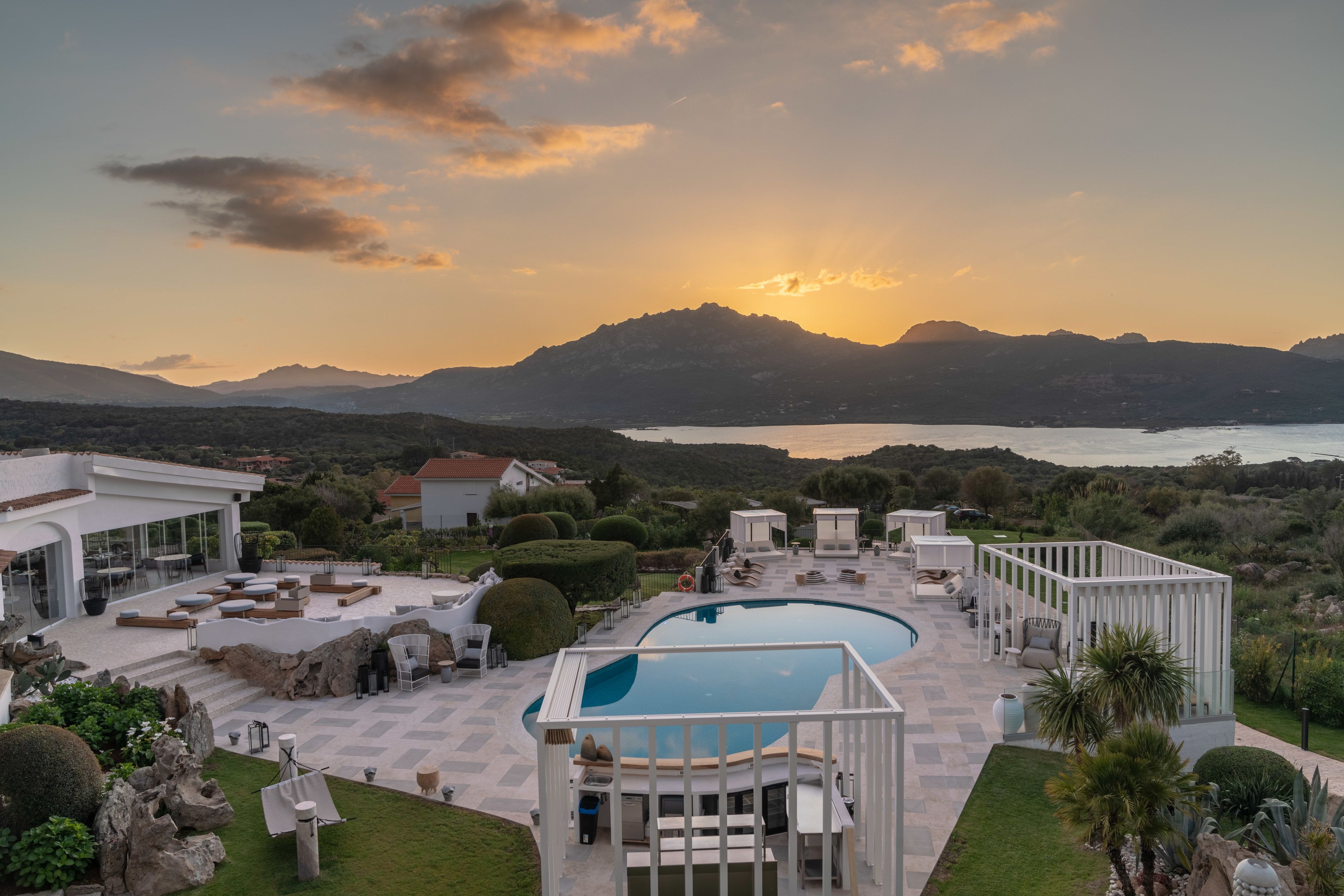 Un resort con piscina, zona de estar y vistas a la montaña.