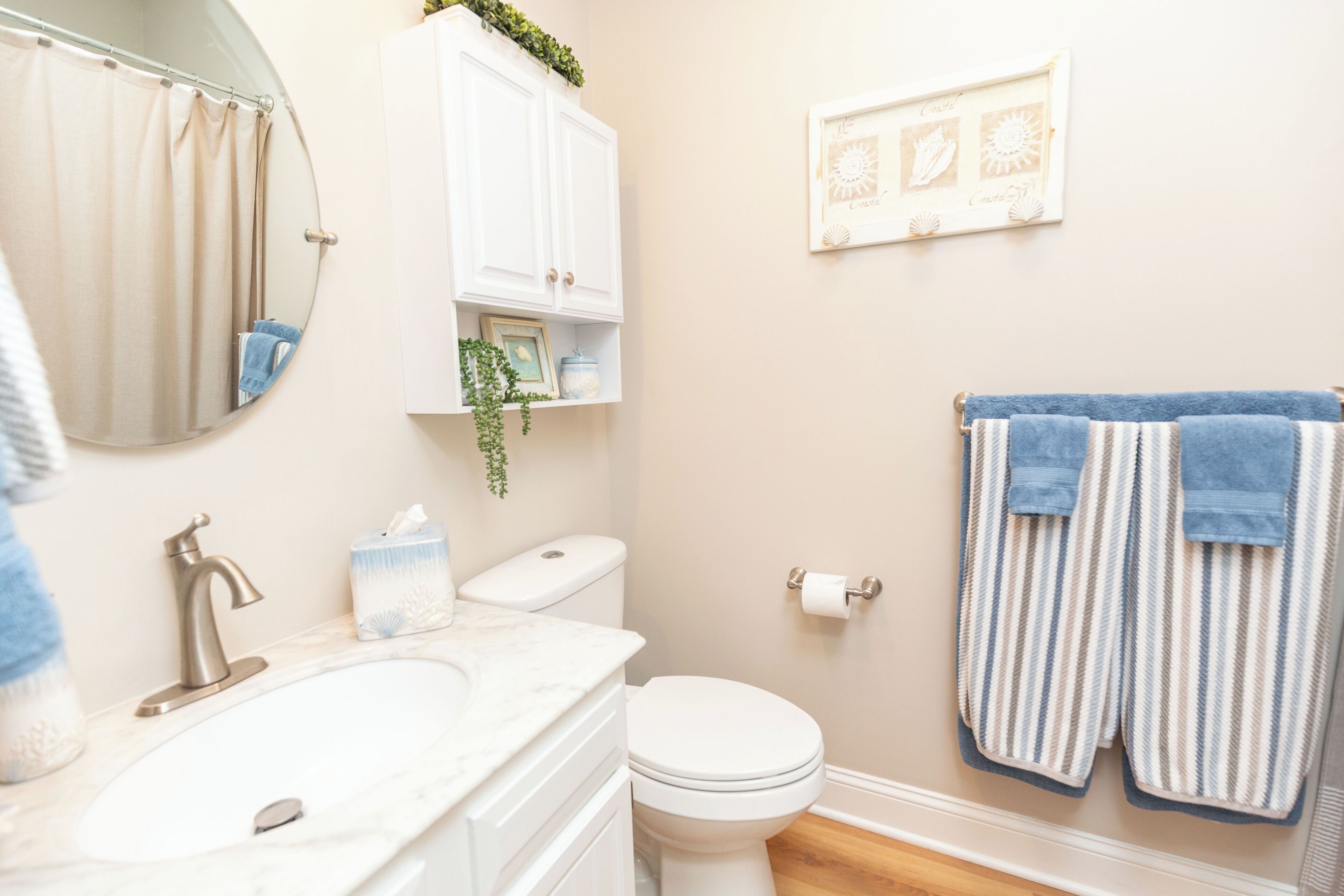 A bathroom with a sink, toilet, and towel rack.